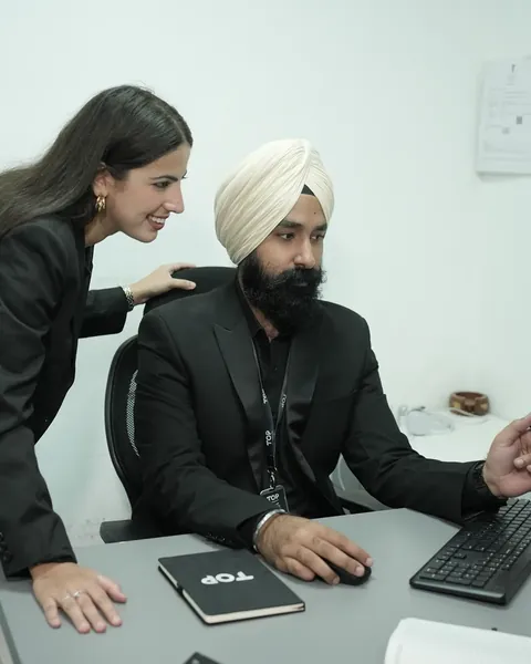 Two TOP colleagues reviewing work together at a desk