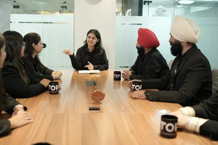 A TOP team member leading a discussion around the meeting table