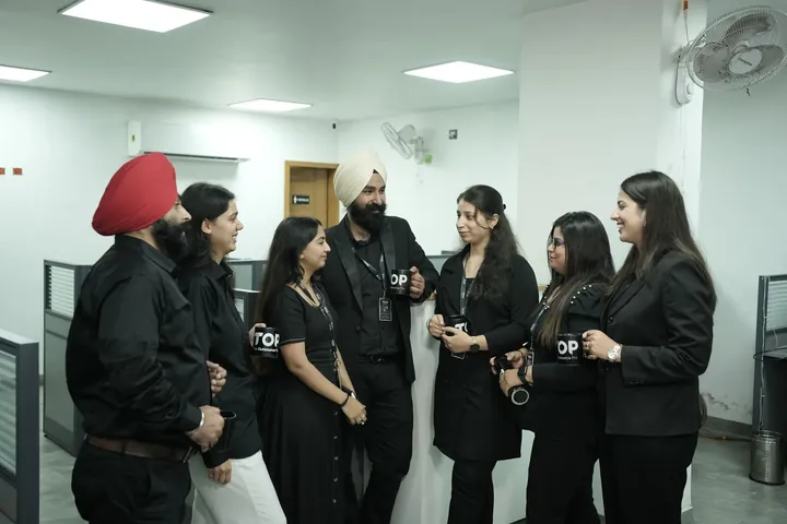 A group of TOP team members standing together in the office
